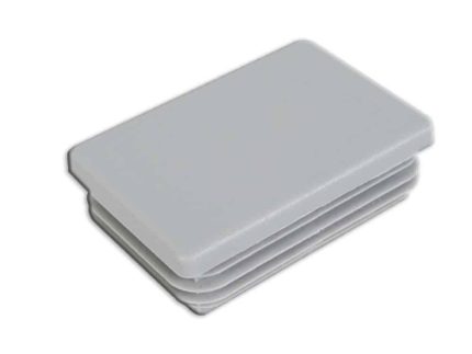 En rektangulær, lysegrå plast endehætte med ribbede sider, designet til et 60x40 mm rektangulært rør eller hul åbning. Denne stolpehatte har en glat, flad overflade og rillede lag på siderne for en sikker pasform.