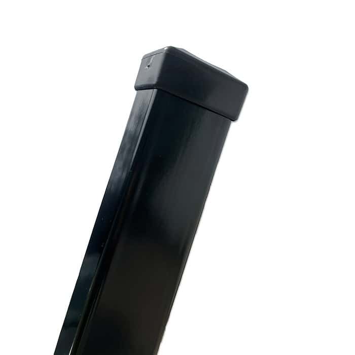 Nærbillede af topsektionen af en Stolpe Stål 60x40mm Pulverlakeret Sort RAL 9005 med beskyttelseshætte. Baggrunden er helt hvid, hvilket understreger stolpens slanke og enkle design og dens rene, glatte overflade.